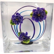 Closeup of underwater design using three purple violet blossoms and loops of wire